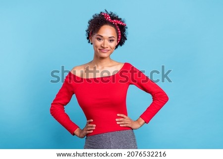 Photo of adorable sweet afro girl wear off-shoulders red shirt arms waist smiling isolated blue color background
