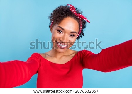Photo of funny sweet afro girl wear off-shoulders red shirt recording self video smiling isolated blue color background