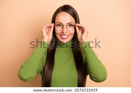 Photo of mature smart lady wear eyewear green pullover isolated on beige color background