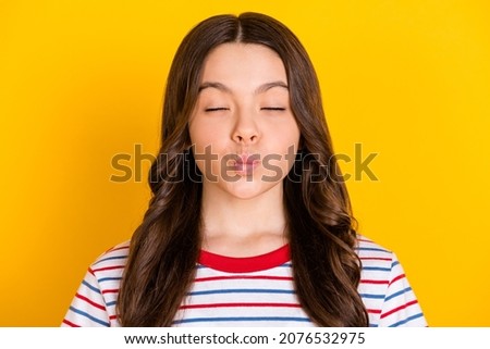 Photo of young charming lovely pretty cute dreamy girl pout lips with closed eye wear t-shirt isolated on yellow color background