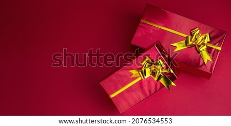 Banner with red Christmas gifts with golden bows. High quality photo