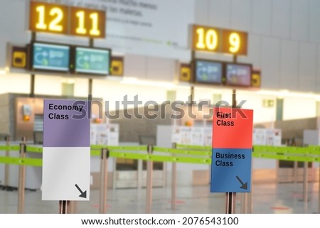 airport signs fo  first , busines and economy class before to the checked in and boarding pass , background unfocused