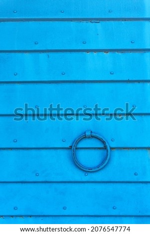 Blue rippled metal background. The texture of horizontal metal plates connected by rivets. Blank for a poster or banner.