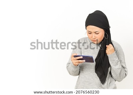 Playing mobile game on Smartphone of Beautiful Asian Woman Wearing Hijab Isolated On White Background