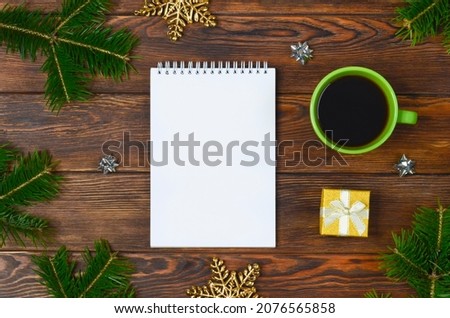 notepad with christmas or new year decoration, template and blank paper with copy space text, business mock up, festive background for plans, goals and resolution.