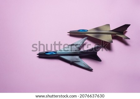 Fighter plane toys on the pink background.
