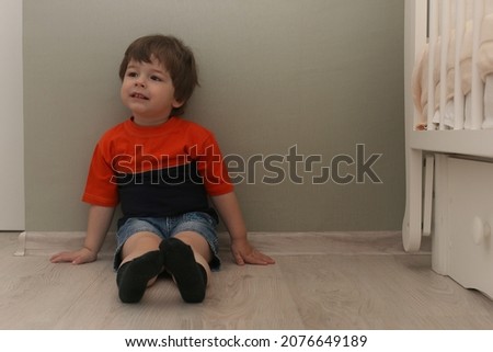 Young kids playing on a floor in a room