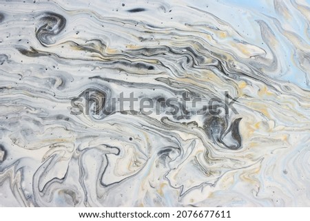 art photography of abstract marbleized effect background with gold, gray, black and white creative colors. Beautiful paint.