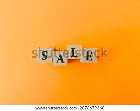 'SALE' wooden word with yellow  wallpaper background