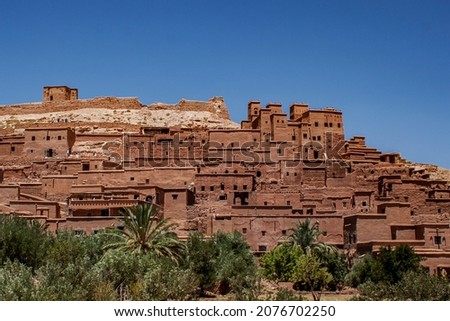 Ksar of Ait-Ben-Haddou, caravan route between the Sahara and Marrakech in Atlas Mountains, Ouarzazate Province, Morocco, Africa. Organic mud-built Berber village of merchants' houses known as kasbahs. Royalty-Free Stock Photo #2076702250