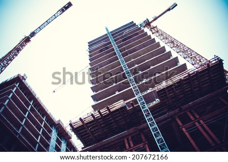 Crane and building construction. big building construction Royalty-Free Stock Photo #207672166