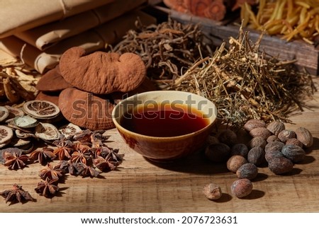 Traditional chinese medicine with herb and spices in brown wooden background mortar and pestile  , a bowl of medicine for advertising , photography traditional content
