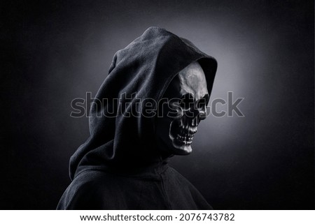 Grim reaper over dark misty background Royalty-Free Stock Photo #2076743782