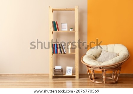 Interior of modern room with shelf unit and armchair