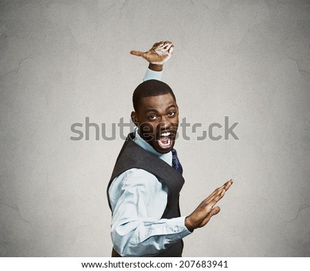 Closeup portrait angry mad furious, company man raising hands in air attack with karate chop isolated grey background. Negative human emotion facial expression feeling, body language, signs, symbols