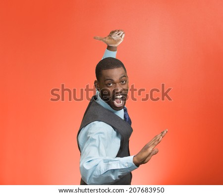 Closeup portrait angry mad furious, company man raising hands in air attack with karate chop isolated red background. Negative human emotion facial expression feeling, body language, signs, symbols