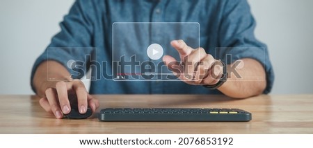Man using computer mouse and keyboard for watching video on the internet, online streaming, online class, content creator
