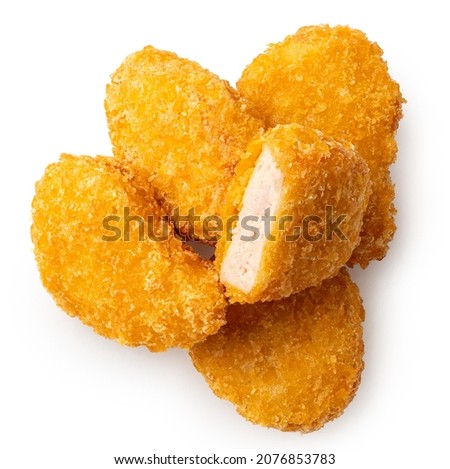 Pile of fried gluten free cornflake crumb chicken nuggets isolated on white. One cut. Top view. Royalty-Free Stock Photo #2076853783
