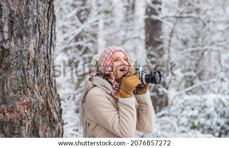 Holiday program. woman hold photo camera. make photo shot of snowy winter nature. cold and beautiful weather. happy hiker girl retro camera. professional photographer winter landscape