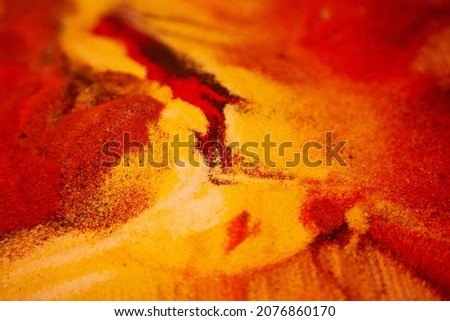 Abstract bright sand background. Red and yellow material for creativity in fluid art style. Beautiful colorful retro molten effect. High quality photo