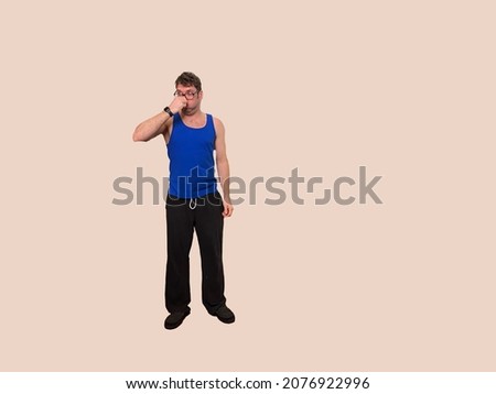 Man in tank top and glasses holds his nose
