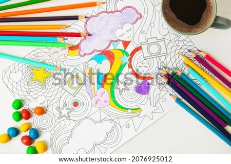 Composition with coloring picture on wooden background