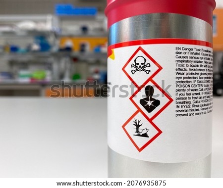 Can with extremely dangerous substance inside, labelled with symbols indicating that the content is toxic, poses health hazard and environmental hazard Royalty-Free Stock Photo #2076935875