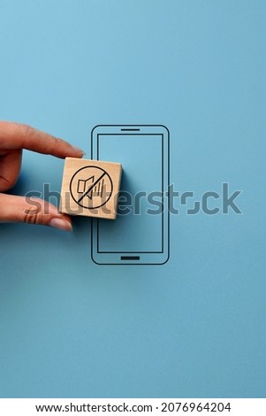Phone number and the "mute" icon. The symbol of the need to turn off the sound on the phone Royalty-Free Stock Photo #2076964204
