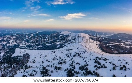 Magical winter panorama of beautiful snowy slopes at a ski resort in Europe on a sunny, windless frosty day. The concept of active recreation in winter
