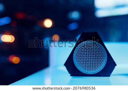 The microphone lies on a glowing table with a grid on the camera. High quality photo