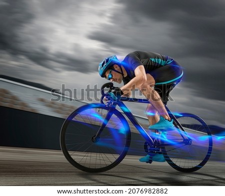 Man racing cyclist in motion on track background. Concept of sport, movement, energy, dynamic, healthy lifestyle Royalty-Free Stock Photo #2076982882