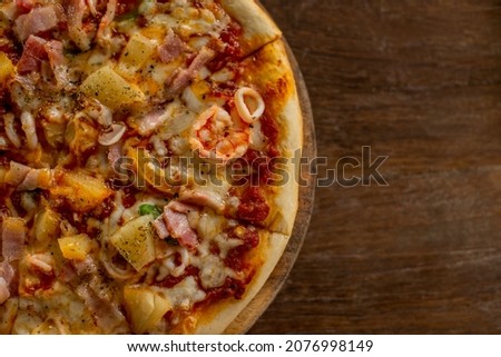 Pizza placed on a wooden tray. 