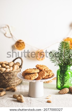 Homemade peanut butter cookies.    Sugar-free flourless cookies.  Cookies in Christmas decoration.  Space for text  