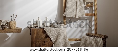 Organic waffle linen towels, bathroom zero waste accessories on solid oak stump in modern bathroom interior. Daily body care, spa and wellness zero waste bathroom concept Royalty-Free Stock Photo #2077018486