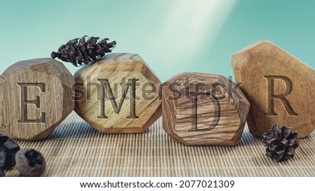 Letters EMDR written on wooden irregular blocks. Eye Movement Desensitization and Reprocessing psychotherapy treatment concept. Royalty-Free Stock Photo #2077021309