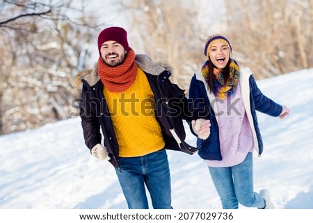 Photo of excited young couple happy positive smile go walk run park hold hands together weekend vacation