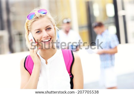A picture of a student talking on the phone in the campus