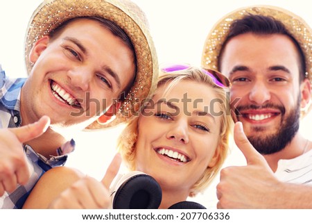 A picture of a group of friends showing ok signs to the camera