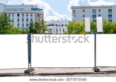 Blank white banner for advertisement mounted on the hoardin of construction site