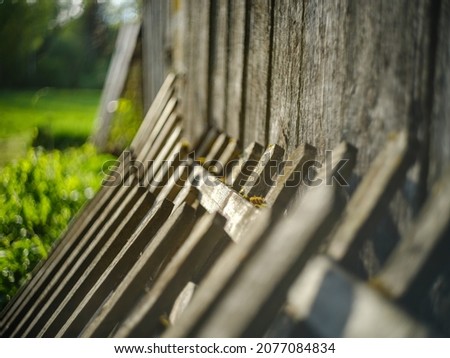 old countryside barn from wooden planks and concrete in rural area in summer