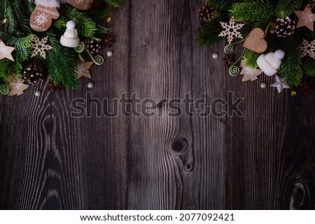 Christmas background with fir branches, red and gold decorations and pine cones on a rustic wooden table. Flat lay. top view with copy space. High quality photo