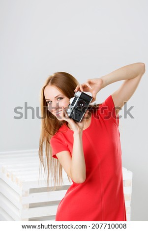 Happy smiling stylish teenager with vintage camera