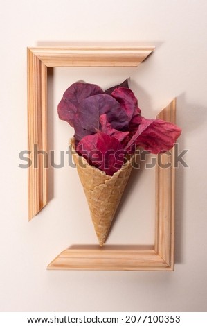 ice cream from colored autumn leaves in trendy color on a beige background. minimalistic concept.