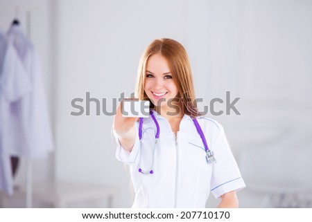 Medical doctor showing business card sign, blank with copy space for text or design. 