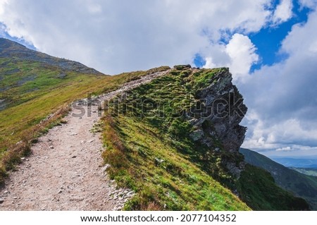 Beautiful hiking trail on top (Starobocianski Wierch or Klin) in Tatras. Border Poland, Slovakia. Carpathian mountains, Europe. Dangerous place over precipice. Extreme travel and adventure in mountain Royalty-Free Stock Photo #2077104352