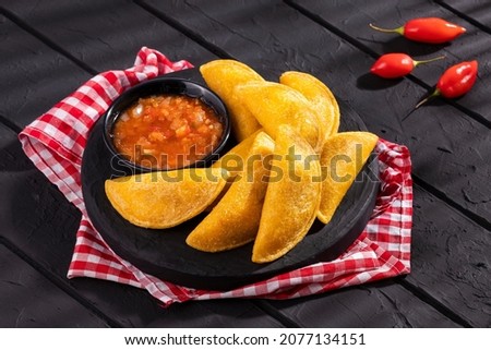 Delicious and traditional Colombian empanadas with spicy sauce Royalty-Free Stock Photo #2077134151