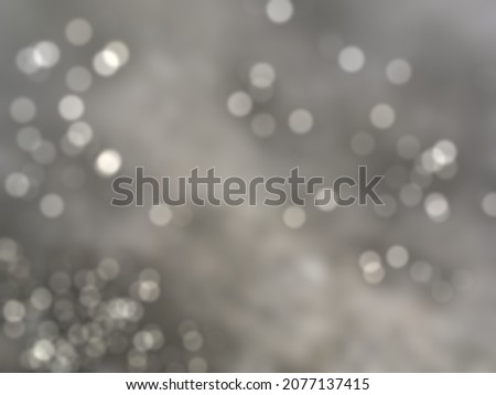 Blurry gray or silver bokeh surface texture background 
