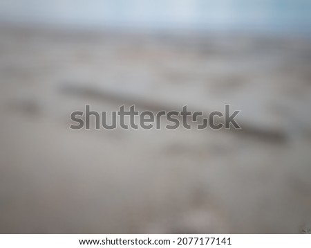 Defocused abstract background of a fallen old branch on the sand