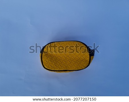 Yellow wallet with black cover on white background