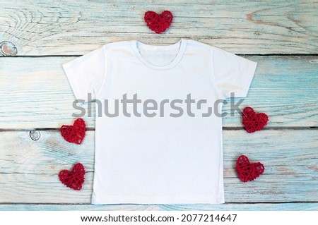 Blank white t-shirt with heart decor, unisex valentine's day apparel mock up. Stock photo